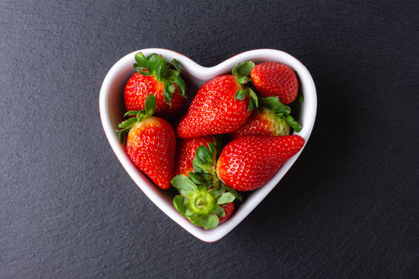 istock Fresh strawberries in heart bowl 1502844564