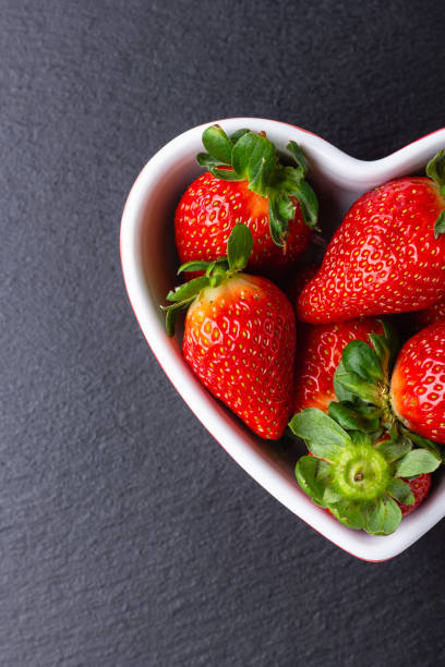 istock Fresh strawberries in heart bowl 1502844568