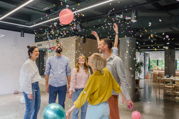 Office party Photo of a group of coworkers having a happy occasion and celebrating together in their office work party stock pictures, royalty-free photos & images