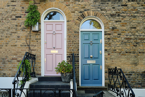 A snapshot of two doors side by side in London, presenting an intimate view of the city's architectural charm and diversity.