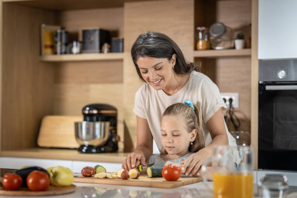 istock Young mother making food with her daughter 1502848314