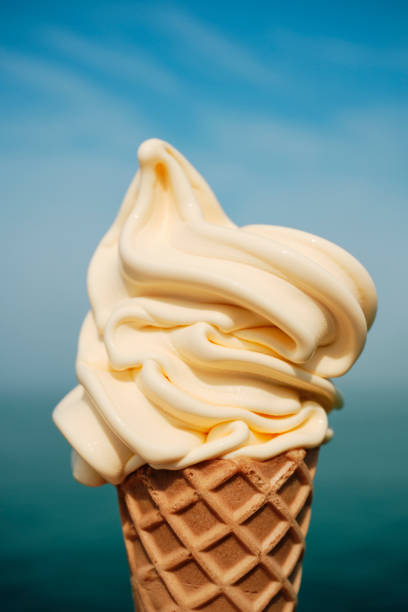 istock Delicious vanilla ice cream cone overlooking defocused sea at Newquay, Cornwall on a bright June day. 1502854408