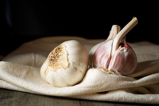 Garlic cloves on a white tablecloth.