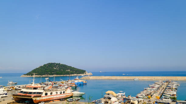 un piccolo porto di pescatori e una piccola isola - turkish culture turkey fishing boat fishing foto e immagini stock