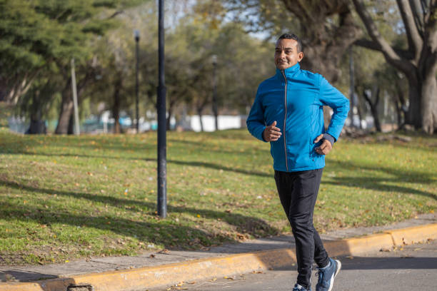 istock Young Latino man runs by a public park. 1502865488