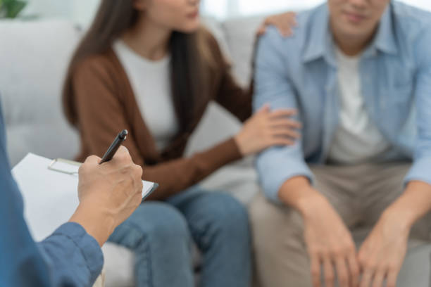 istock Couple hold hand support each while discussing family issues with psychiatrist. Husband encourages and empathy wife suffers depression. psychological, save divorce, Hand in hand together, trust, care 1502869720