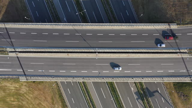 Aerial shot of vehicles on freeway overpass from drone pov
