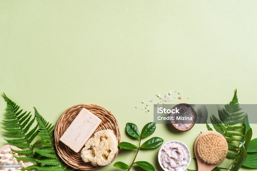 Natural Spa Background Spa Background. Natural organic spa cosmetics products with green leaves, eco friendly bathroom accessories. Bodycare concept on green background, copy space. Massaging Stock Photo