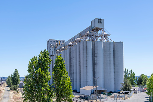 Seatlle, WA, USA-July 2022; View of a large grain elevator complex near train and port facilities for export from the northeast shore of US
