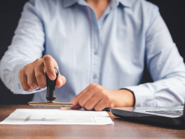 istock Businessman stamping approved on documents while sitting working in the office 1502873341