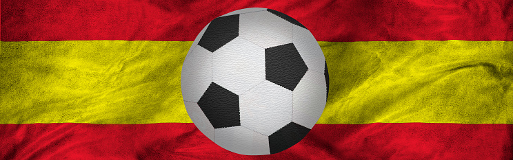 The image of a soccer ball against the background of the national flag of Spain