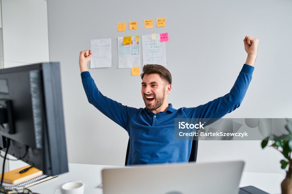 Young Male Programmer Celebrates Success After Solving A Problem While ...