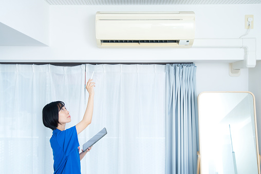 Adjusting the temperature of the air conditioner in the room