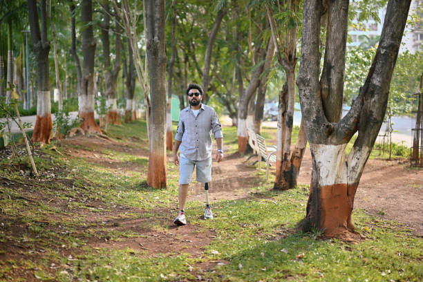 istock Man with a prosthetic leg confidently walking through trees in nature 1502879388