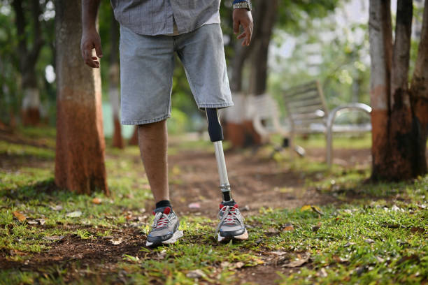 The picture showcases a serene natural landscape, with tall trees, vibrant foliage, and a carpet of lush grass beneath the man's feet. The scene exudes tranquility and offers a refreshing escape into nature. This picture serves as a powerful visual metaphor for overcoming obstacles and embracing personal strength.
