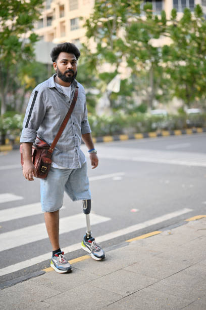 istock A man with a prosthetic leg crossing the road using a pedestrian crossing 1502879864
