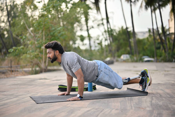 istock Man with a prosthetic leg doing push-ups outdoors 1502880117