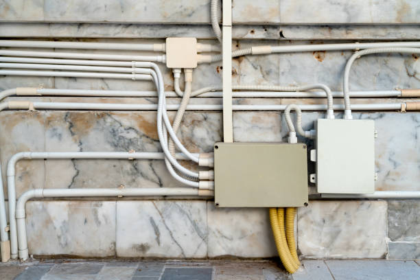 electrical junction boxes with plastic pipe connection on marble wall background electrical junction boxes with plastic pipe connection on marble wall background coalition building stock pictures, royalty-free photos & images