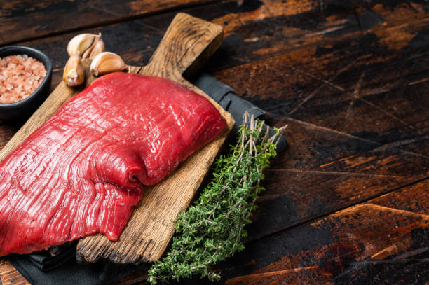 istock Alternative flank beef steak, raw meat. Wooden background. Top view. Copy space 1502881226