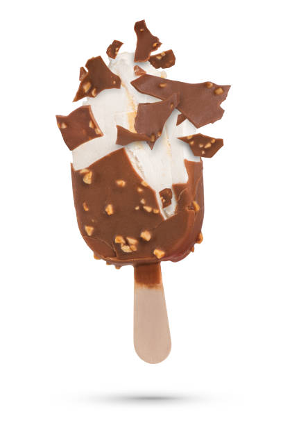 istock Chocolate ice cream isolate on a stick flying pieces of chocolate icing. Chocolate ice cream on a white isolated background with scattered pieces of chocolate and vanilla inside. 1502881647