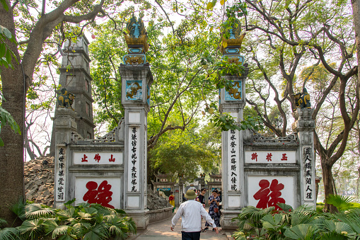 Hanoi, Vietnam-April 2023; Entrance gate to the The Huc Bridge that links the sacred Buddhist Ngoc Son Temple and the bank of Hoan Kiem Lake in the center of Hanoi
