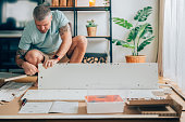 Man assemble furniture at home