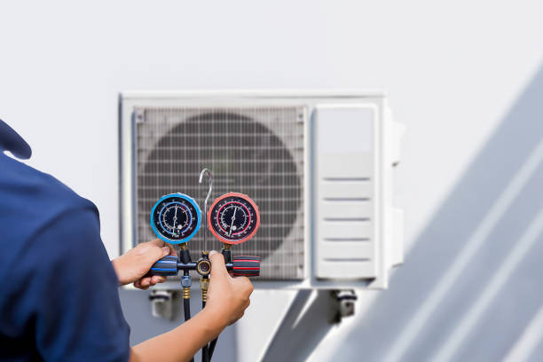 istock Air conditioning, HVAC service technician using gauges to check refrigerant and add refrigerant. 1502883897