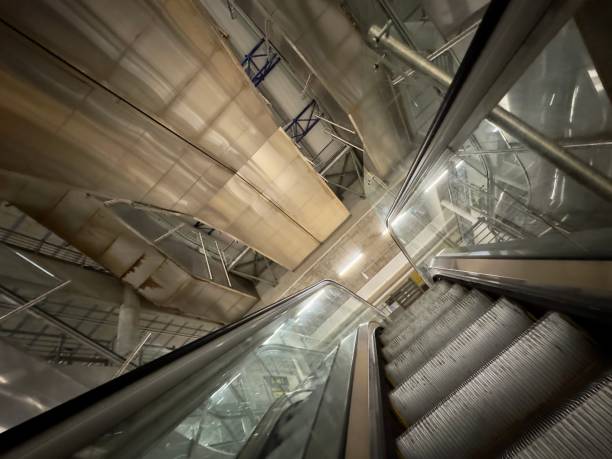 istock Wide angle of escalator going up in a concrete building 1502885451