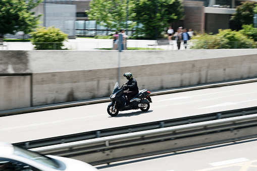A scooter motorbike in motion on a city street