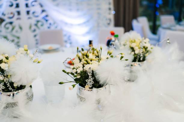 istock two vases filled with white flowers on top of a table 1502889148
