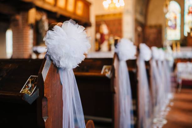 istock Church pew adorned with white ribbons, tied into a bow 1502889163