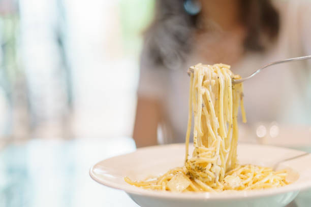 istock Woman eating spaghetti carbonara. 1502889399