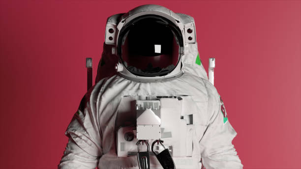 istock Astronaut's head close-up on a pink isolated background with changing lighting. Chroma key. Helmet. Advertising 1502890090