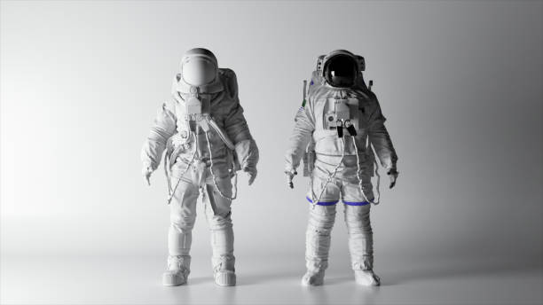 istock Two astronauts in white spacesuits stand on a white background. Lighting is changing. Black and white helmet. 1502890092