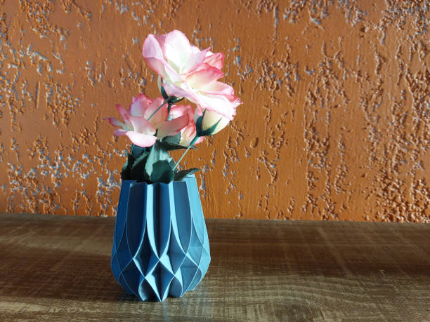 istock Vase with artificial flowers on a wooden table 1502890737