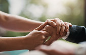 Closeup, hands and support with hope, healing together and praying with trust, compassion and empathy. Zoom, elderly person and caregiver touching palms, compassion or sympathy with grief and health