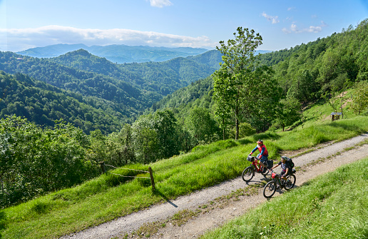 active senior couple on a bike tour with their electric mountain bikes in the Karst Mountains of Slovenia near Tolmin