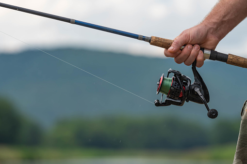 Casting a Fly Fishing Rod in Mountain Lake