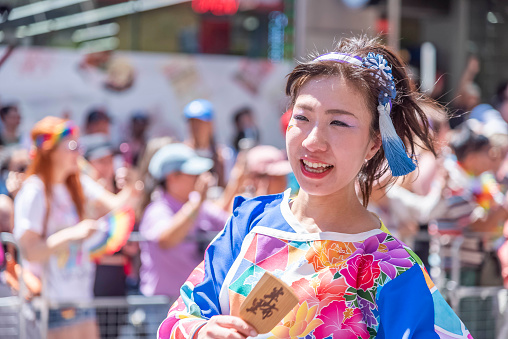 Toronto, Ontario, Canada - June 24, 2023: A Japanese woman excited to be at Toronto's annual Pride parade.