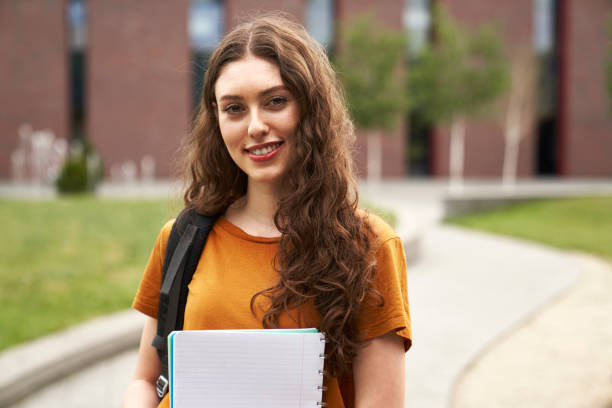 istock Portrait of caucasian university student standing outside the university campus 1502898310