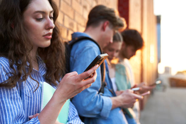 istock University students browsing phones next to university campus building 1502899983