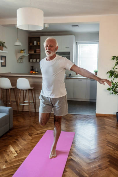 istock Senior man doing fitness workouts and stretching at home. 1502901577