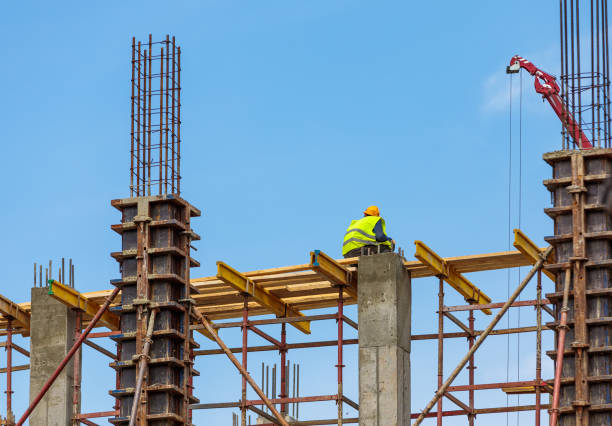 istock A male construction worker stands on reinforced concrete beams at a height. 1502904461