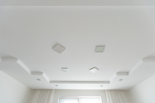 Classic white glossy ceiling with recessed spotlights. High quality photo