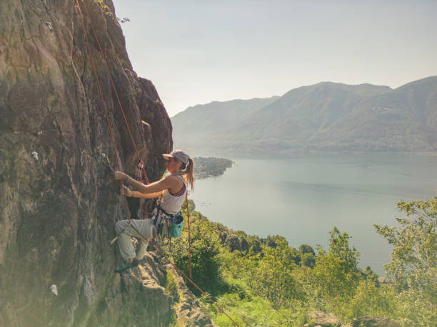 Young woman rock climbing on steep wall