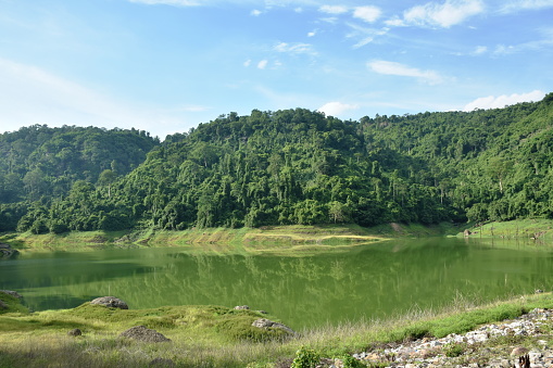 landscape of Klong Klang water reservoir lake with mountain background in Thailand