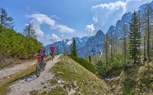 active senior couple on a mountain bike tour at Vršič Pass in the Triglav National Park, Julian Alps above Kranska Gora in Slovenia