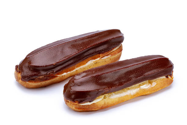 istock Traditional french dessert. Isolated two eclairs with custard and chocolate icing on white background. Sweet pastry products 1502916291