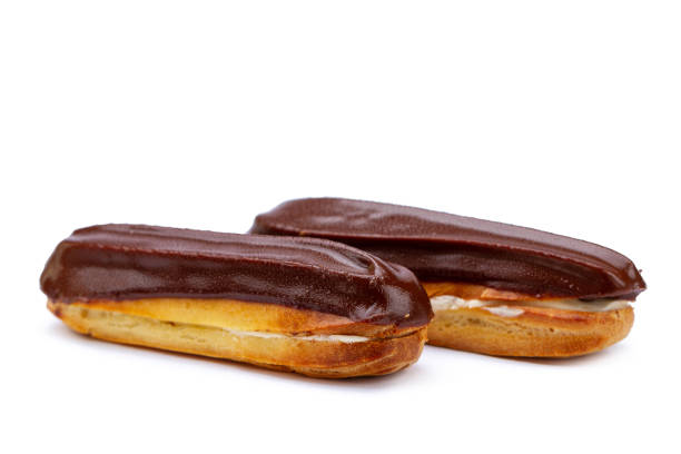 istock Traditional french dessert. Isolated two eclairs with custard and chocolate icing on white background. Sweet pastry products 1502916295