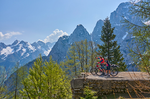 active senior couple on a mountain bike tour at Vršič Pass in the Triglav National Park, Julian Alps above Kranska Gora in Slovenia
